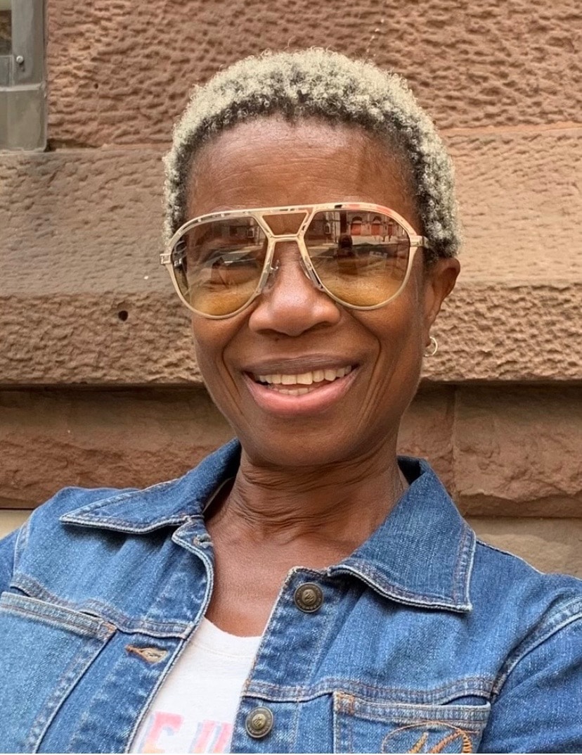 Person in denim jacket wearing EYECON 87 frames